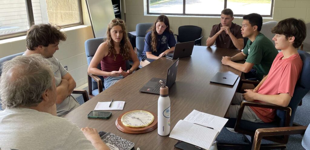 Students discussing their GIS analysis with local stakeholders, Summer, 2025. From left: Jeff Donze, Cohasset Conservation Trust; Jonathan Loja, Cohasset Supt., Water Dept.; Roze Guzman, and Charlotte Lynch of Scituate; Wilson Nussbaum of Cohasset; and Randy Chen and Will Crespi of Hingham